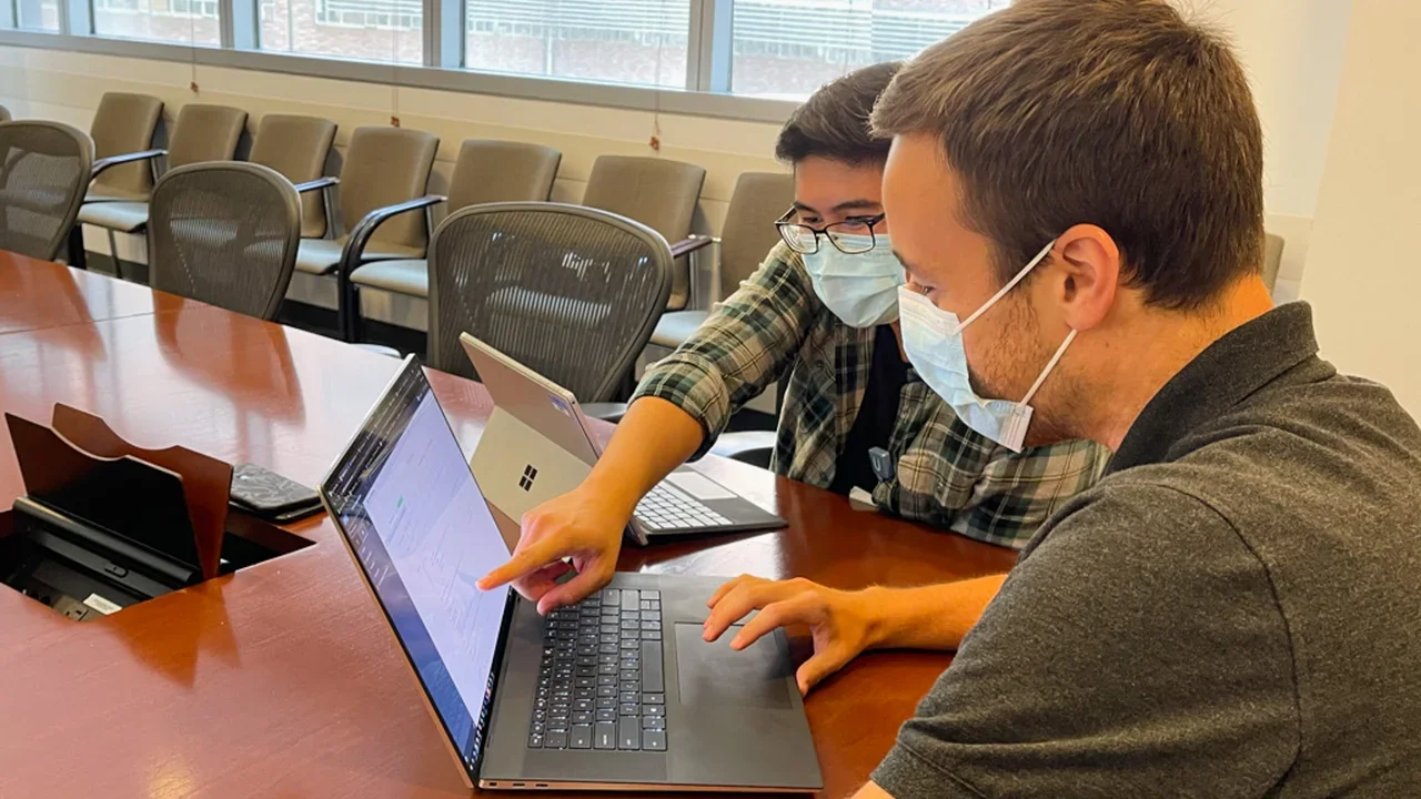 Technicians looking at a computer
