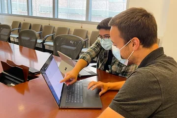 Technicians looking at a computer