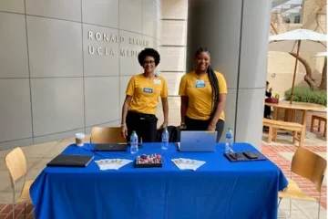 UHIT staff in front of a table at the Ask me about myUCLAhealth event. 