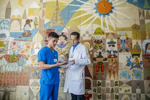 Student and doctor looking over papers