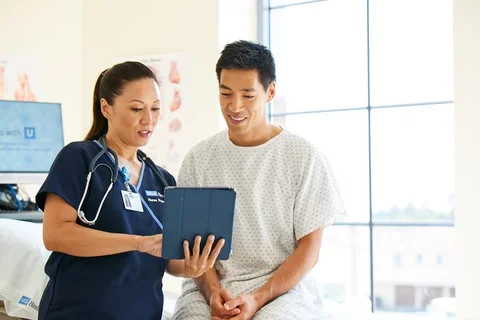 Nurse training patient on an iPad