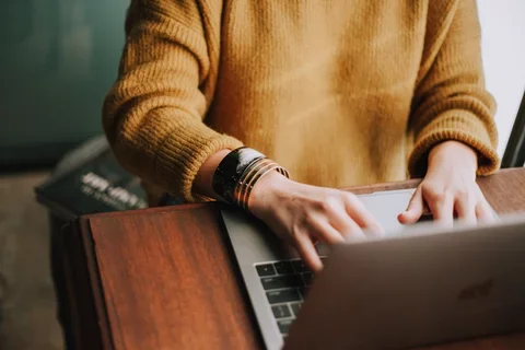 Woman typing on a laptop