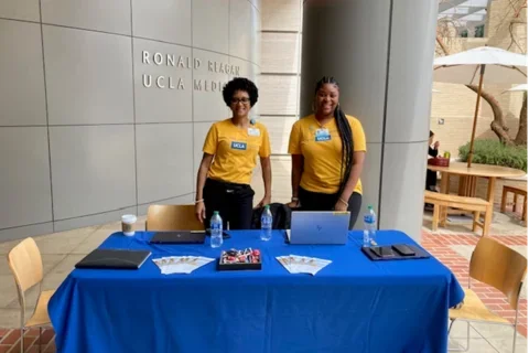 UHIT staff in front of a table at the Ask me about myUCLAhealth event. 