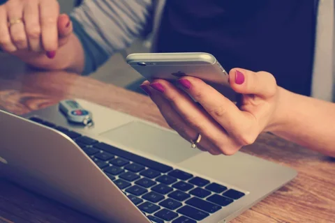 Image of woman holding a phone