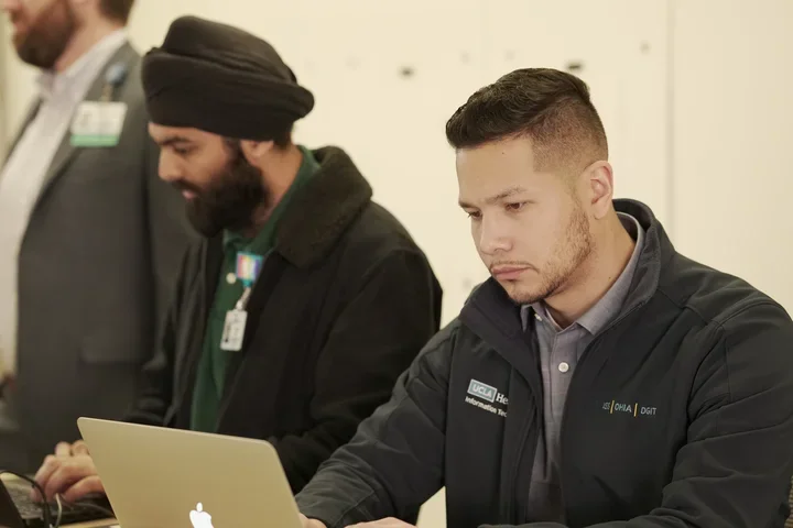 IT techs working on their laptops