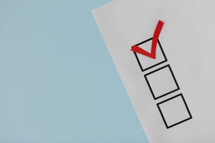 A simple white paper checklist with one red checkmark