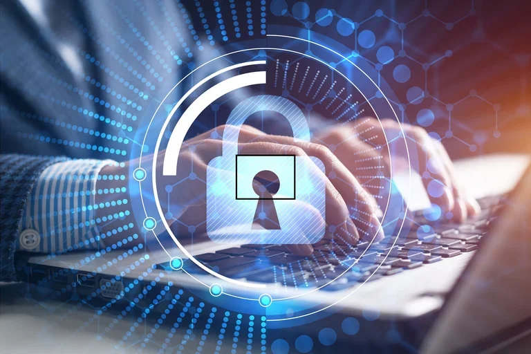 Lock superimposed over a person working on a laptop