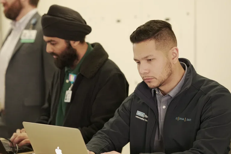 IT techs working on their laptops