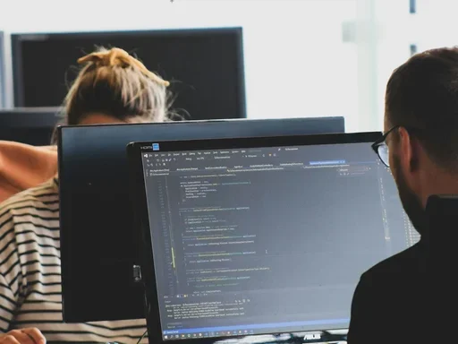 Two people sitting in front of their computers