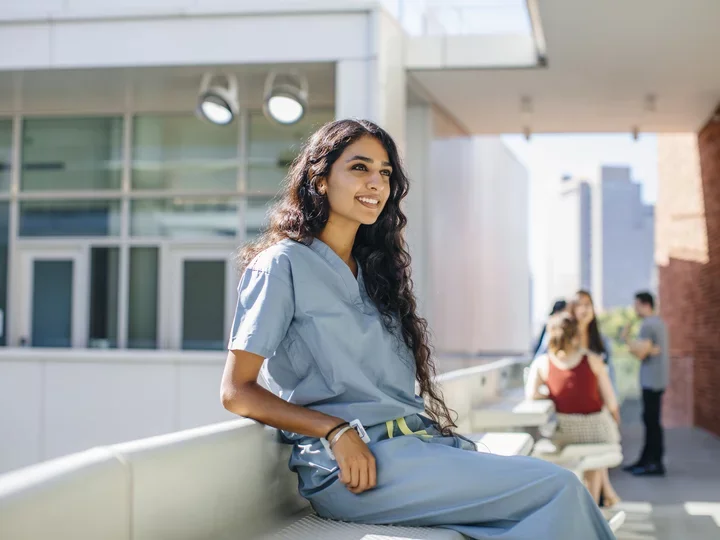 Student sitting outside building