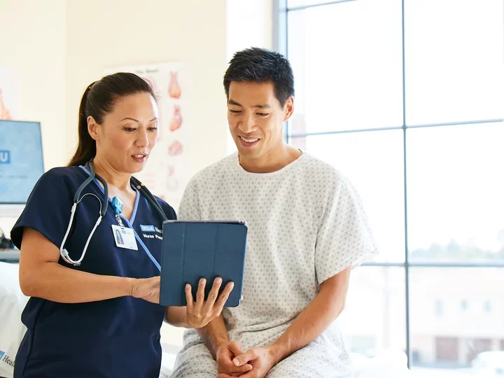 Nurse training patient on an iPad