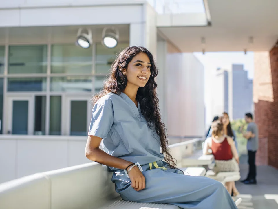 Student sitting outside building