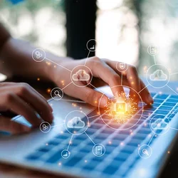 Person typing on laptop keyboard