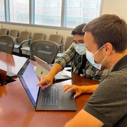 Technicians looking at a computer