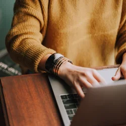 Woman typing on a laptop