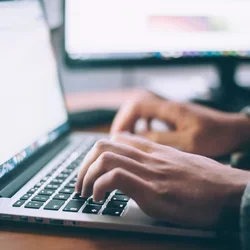 Man typing on a laptop