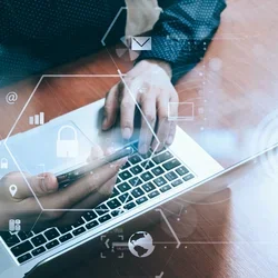 Person on a laptop with security icons 