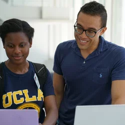 Image of It support staff assisting student