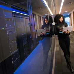 Woman working outside of a networking closet