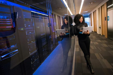 Woman working outside of a networking closet